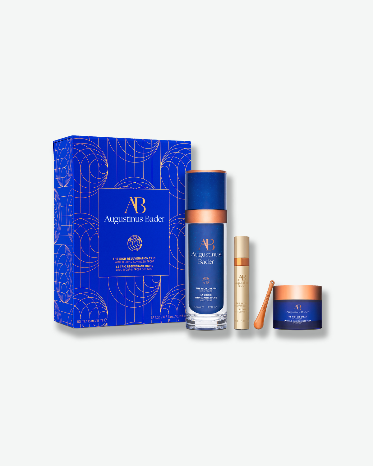 Augustinus Bader The Rich Rejuvenation Trio featuring The Rich Cream, The Elixir, and The Rich Eye Cream beside the blue gift box.