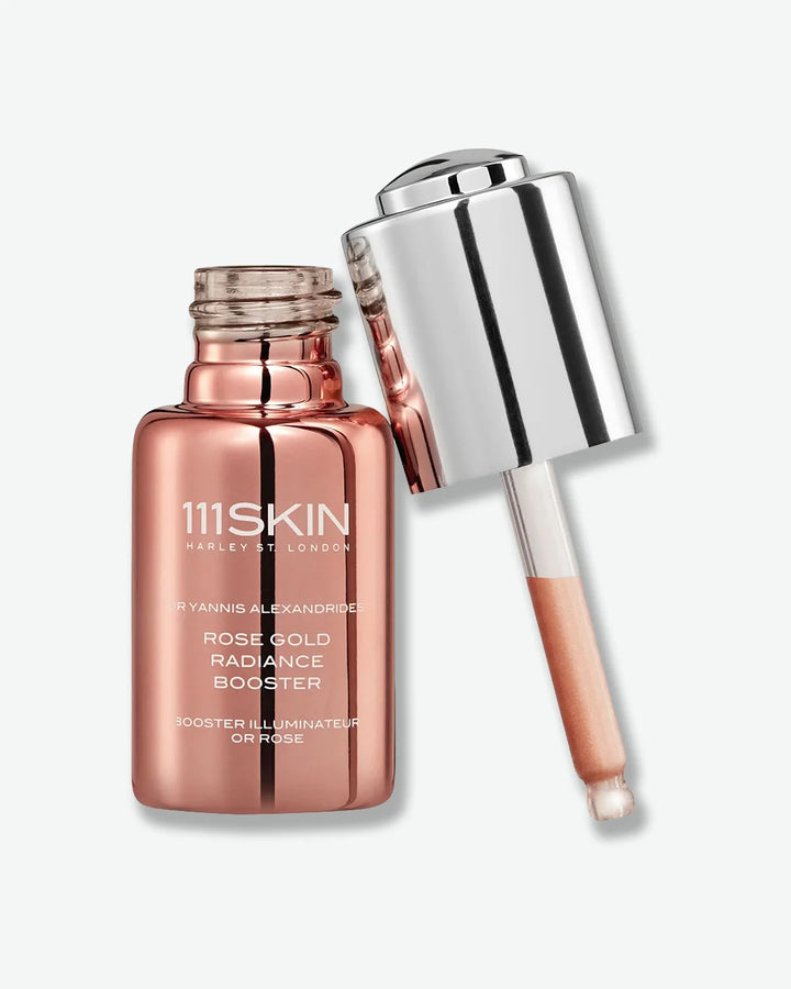 Rose gold bottle of 111Skin rose gold radiance booster with silver cap dropper on a white background