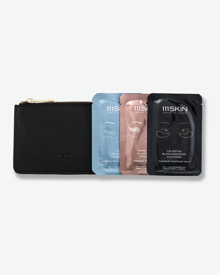 Set of 3 skincare masks - one blue, pink, and black stood next to a black pouch with zipper on a white background