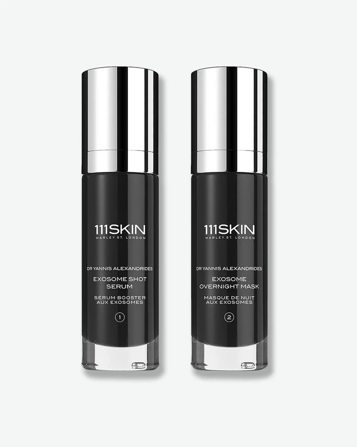 One bottle of 111Skin Exosome Shot Serum with silver cap stood next to one bottle of 111Skin Exosome Overnight Mask with silver cap on a white background