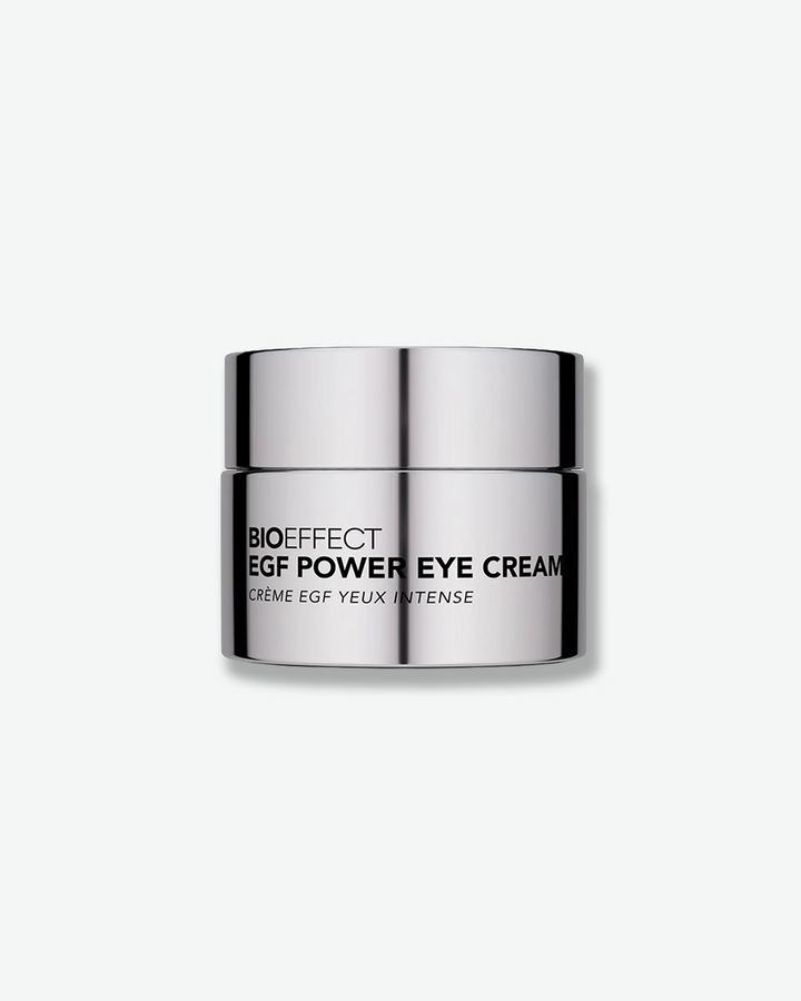 Front view of a Bioeffect EGF Power Eye Cream jar centered against a plain gray background. The compact skincare container is made of a highly polished, reflective silver metal with the brand and product name printed across the front in a bold black font.