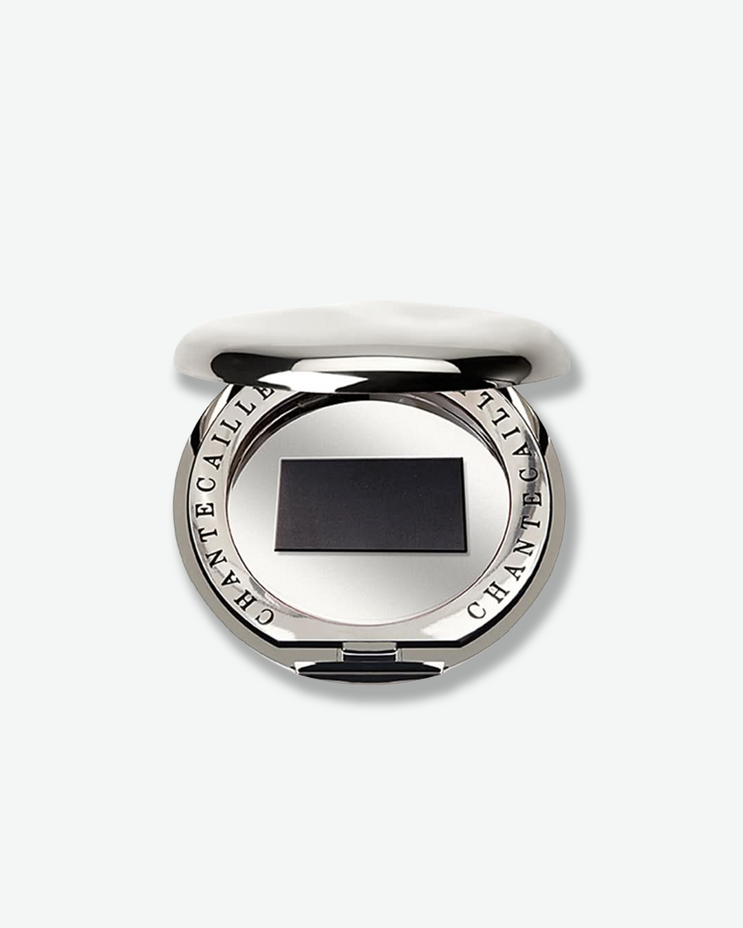 Silver compact mirror with black center on a white background