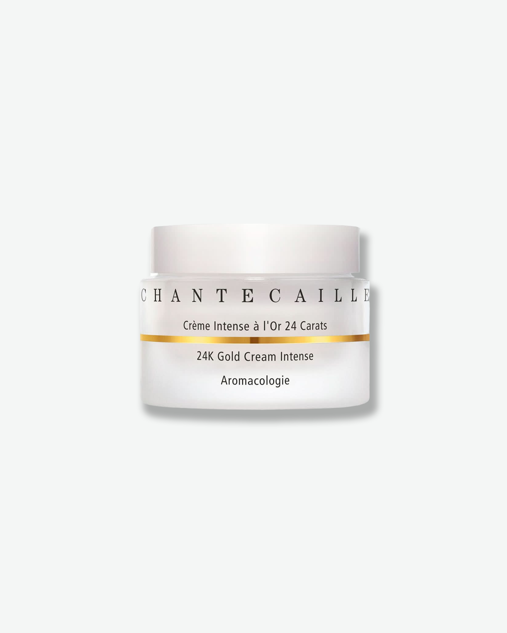 Front view of a Chantecaille 24K Gold Cream Intense jar against a plain gray background. The frosted white glass jar is accented by a thin, horizontal metallic gold stripe running through the center, below the black brand name and above the product description, and is topped with a matte white cap.