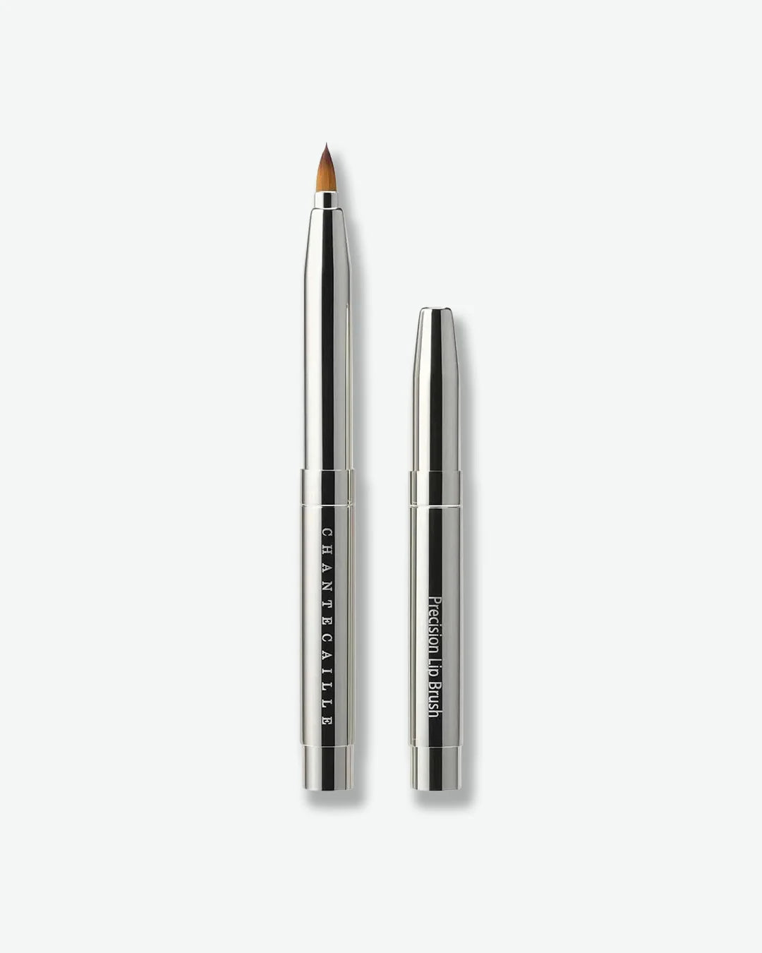Silver makeup brush with black handle on a white background