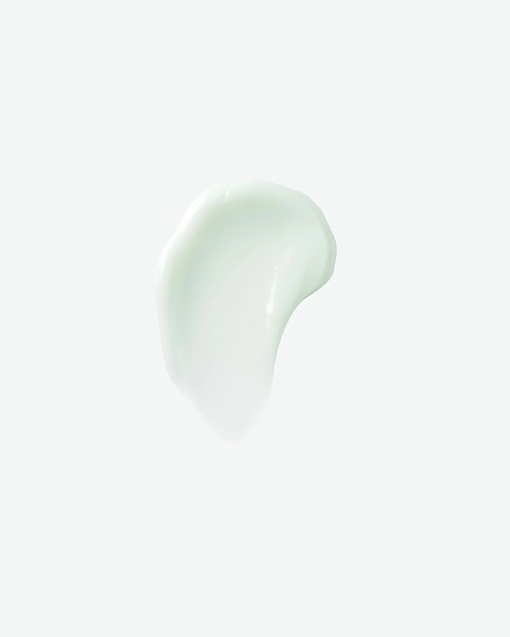 A top-down product texture shot featuring a smooth, curved swipe of light seafoam-green gel cleanser isolated against a clean, minimalist white background.