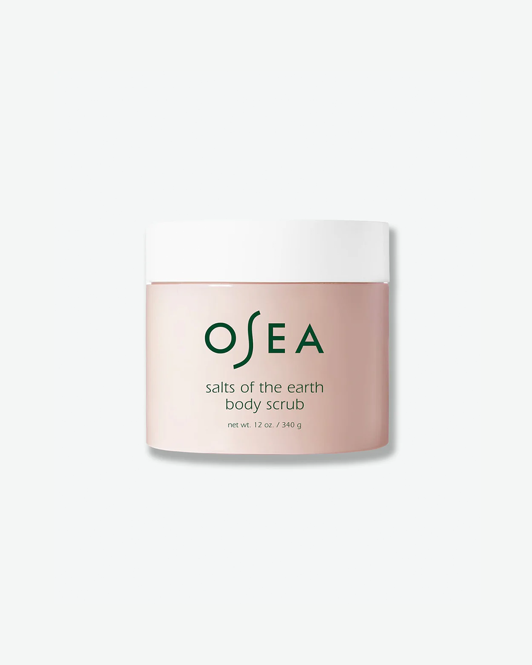 A vertical product shot of OSEA Salts of the Earth Body Scrub in a 12 oz (340 g) jar. The jar is a smooth, translucent pinkish-tan color with a solid white screw-on lid. The dark green OSEA brand logo and product information are printed cleanly on the front.