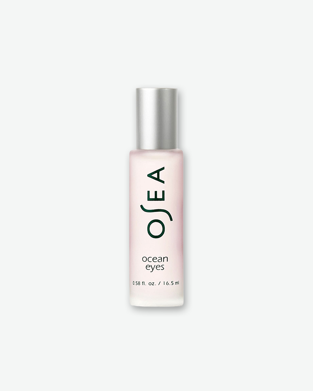 A product shot of an OSEA Ocean Eyes rollerball bottle, centered against a plain light gray background. The slim, cylindrical bottle is made of frosted clear glass, revealing a pale pink translucent serum inside. It is topped with a smooth, brushed silver metallic cap. The front displays the brand name "OSEA" printed vertically in dark green, above the words "ocean eyes" and the volume "0.58 fl. oz. / 16.5 ml".