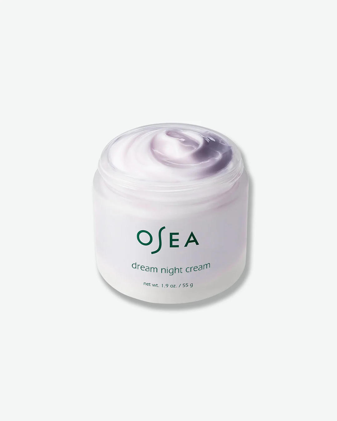 An angled, open-container shot of an OSEA Dream Night Cream jar with the lid removed. The wide, frosted glass jar is filled with a thick, glossy night cream that features a soft white and lavender-purple swirled texture. The dark green OSEA logo and product details are printed on the front of the jar against a plain white background.