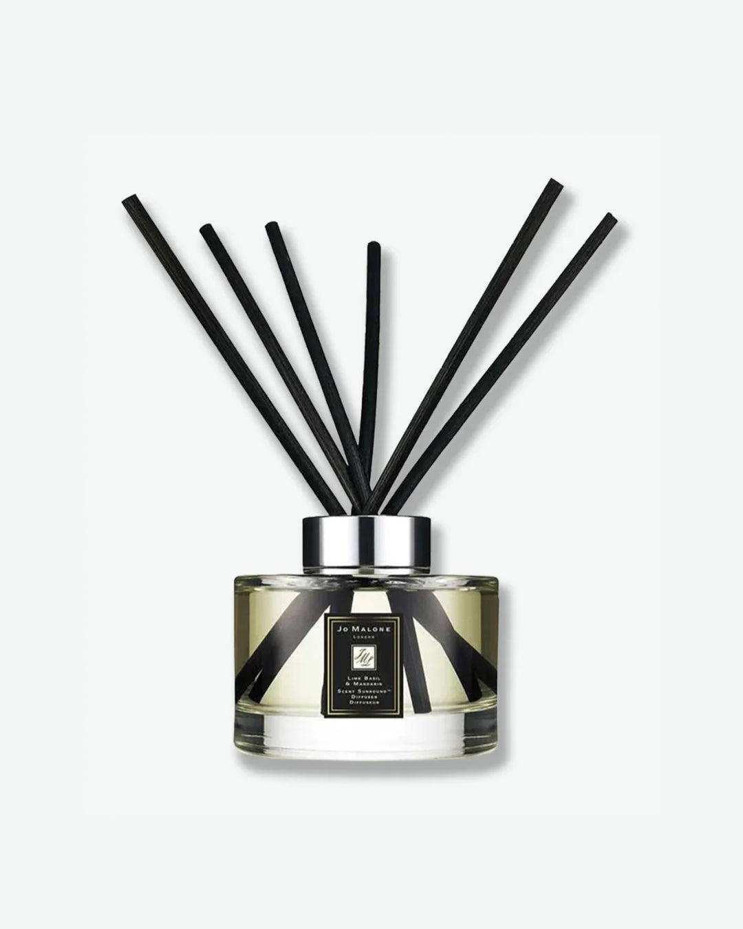 Reed diffuser with black sticks on a white background