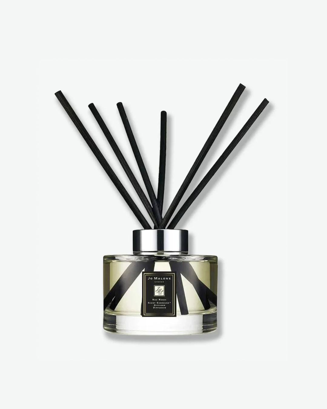 Reed diffuser with black reeds on a white background
