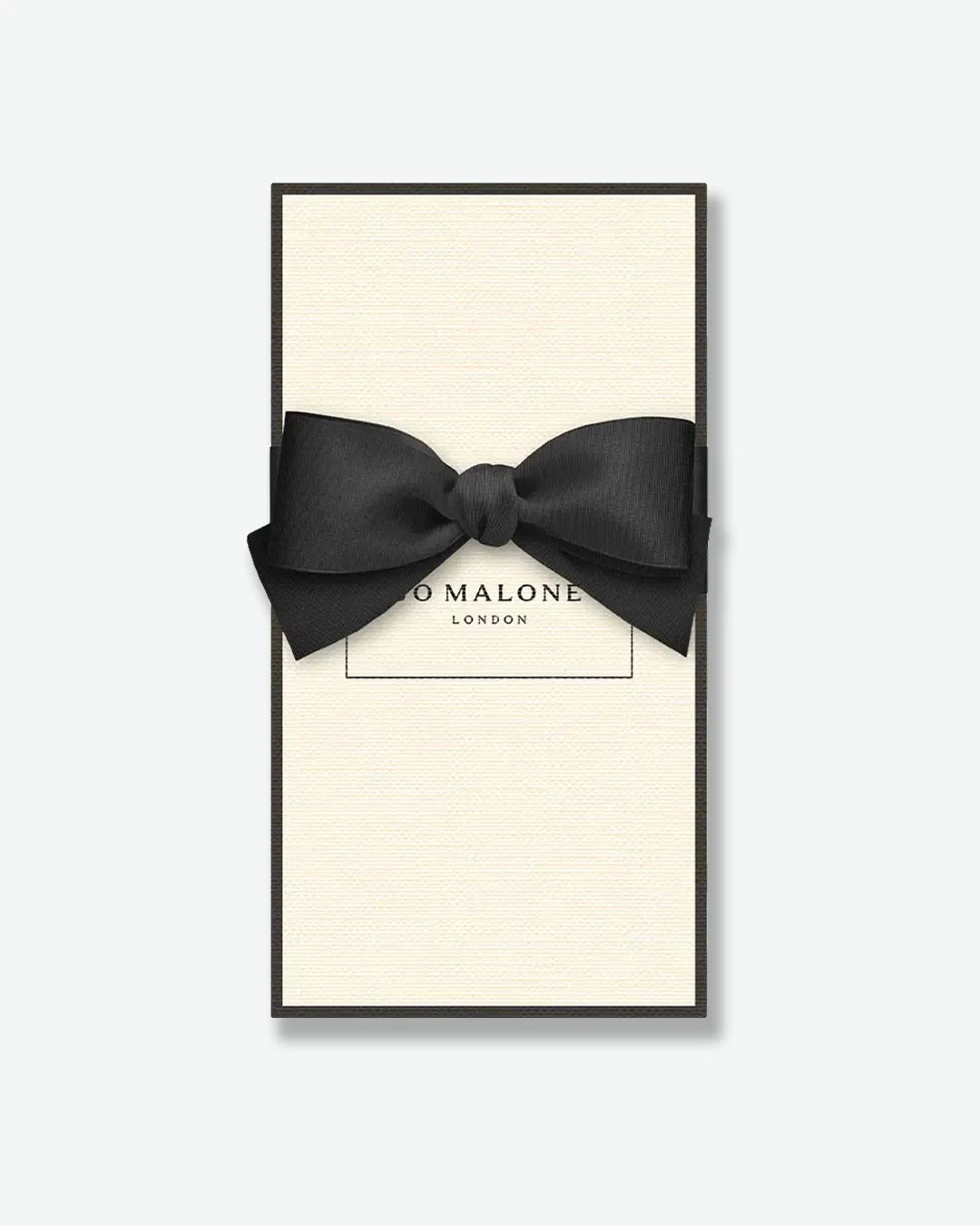 Black bow tie in a 'Jo Malone London' box on a white background