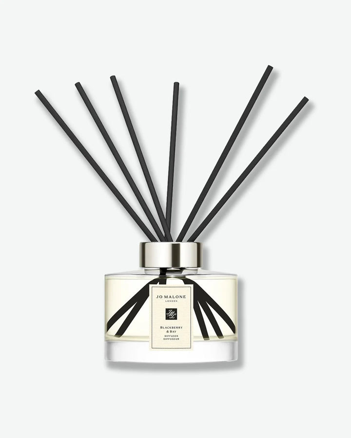 Jo Malone glass jar diffuser with black reeds on a white background