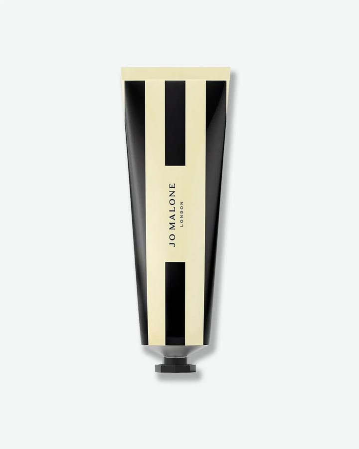 Jo Malone London black and cream striped tube of English Pear & Freesia hand cream with a black top.