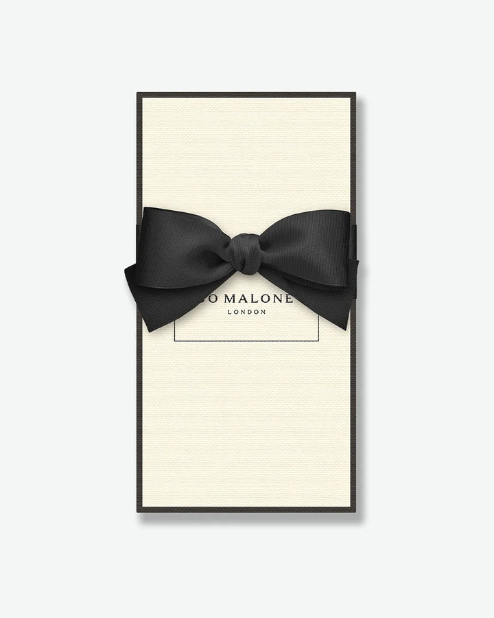 Signature Jo Malone London cream colored gift box with a black ribbon on a white background