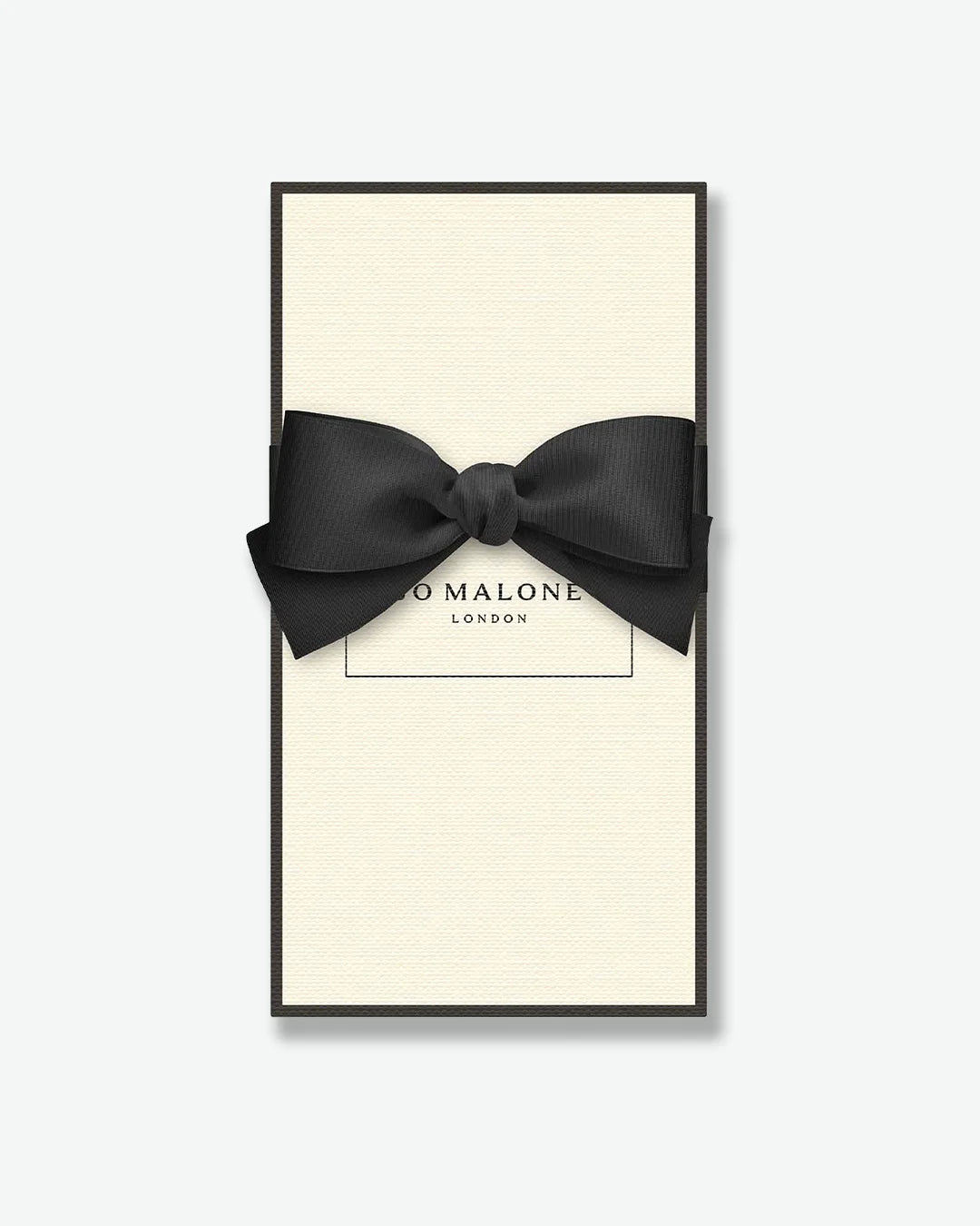 Black bow tie in a 'Jo Malone London' box on a white background