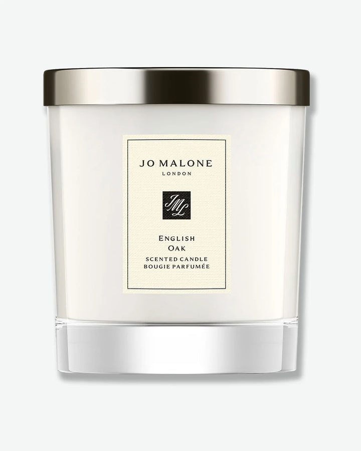 Jo Malone English Oak scented candle in a glass jar with silver lid on a white background

