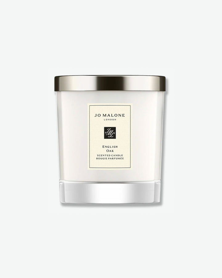 Jo Malone English Oak scented candle in a glass jar with silver lid on a white background