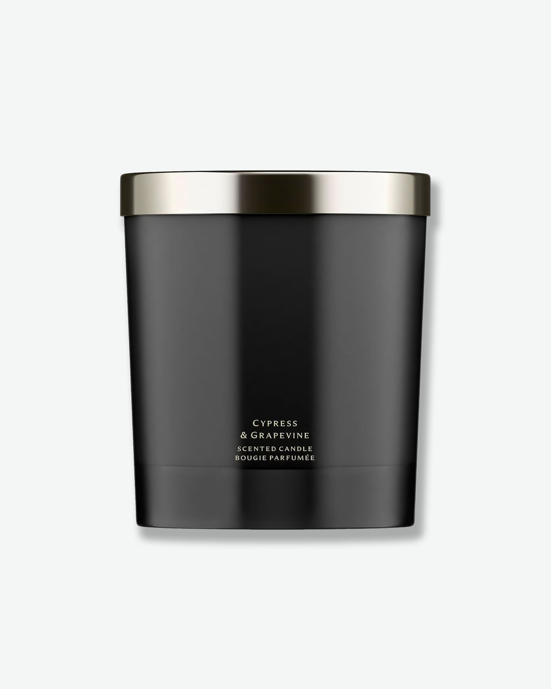 Black candle with silver lid on a white background