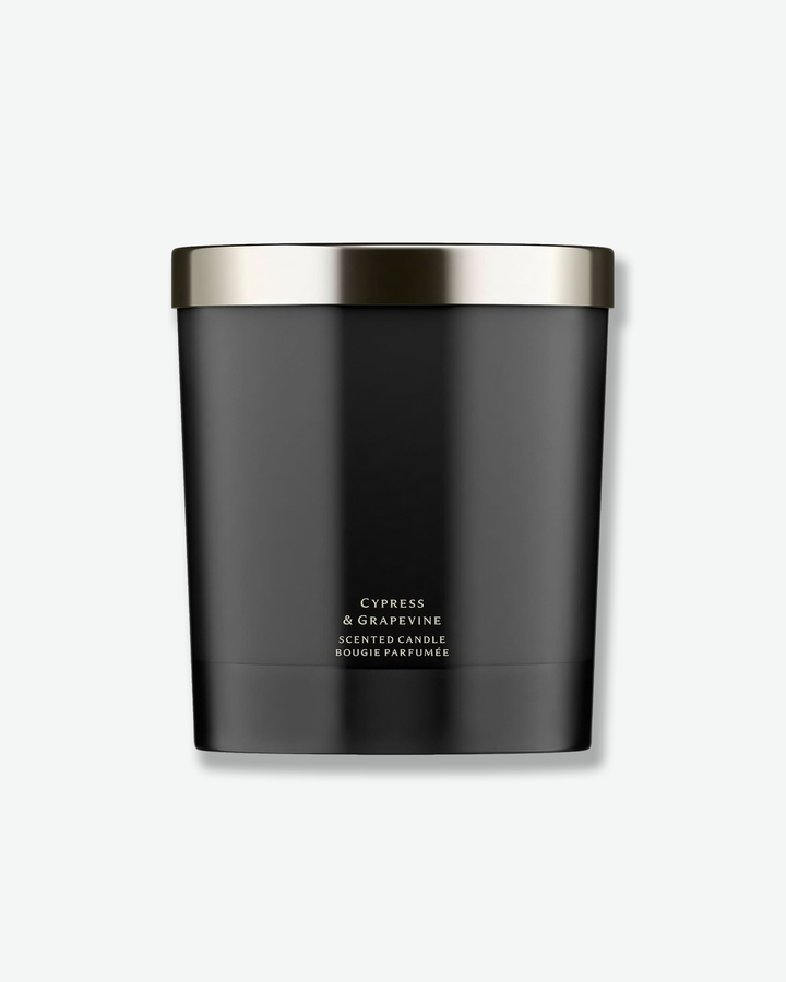 Black candle with silver lid on a white background