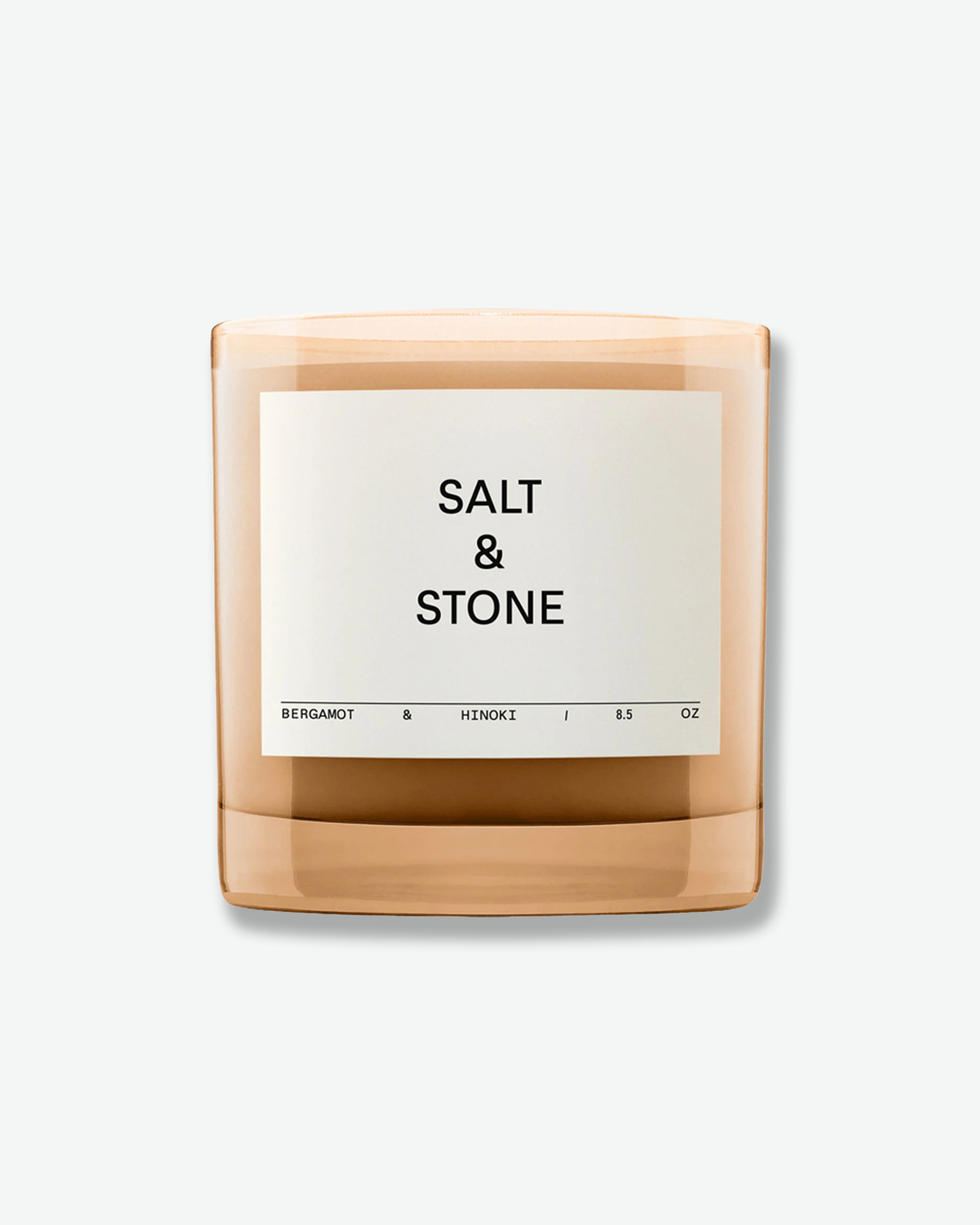 Candle with 'Salt & Stone' branding on a white background