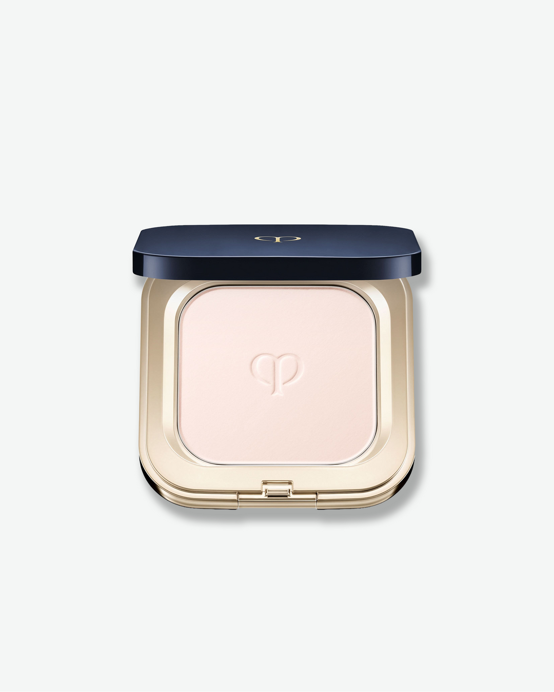 Compact powder in a gold case with a blue lid on a white background