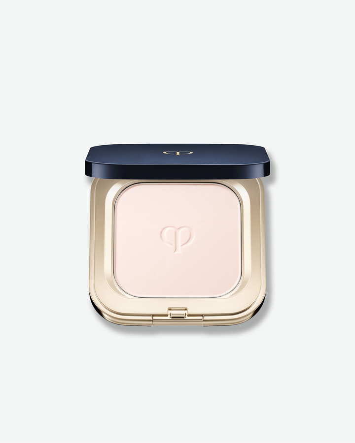 Compact powder in a gold case with a blue lid on a white background
