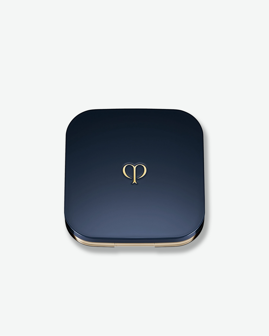 Blue square compact with gold rim and logo on a white background