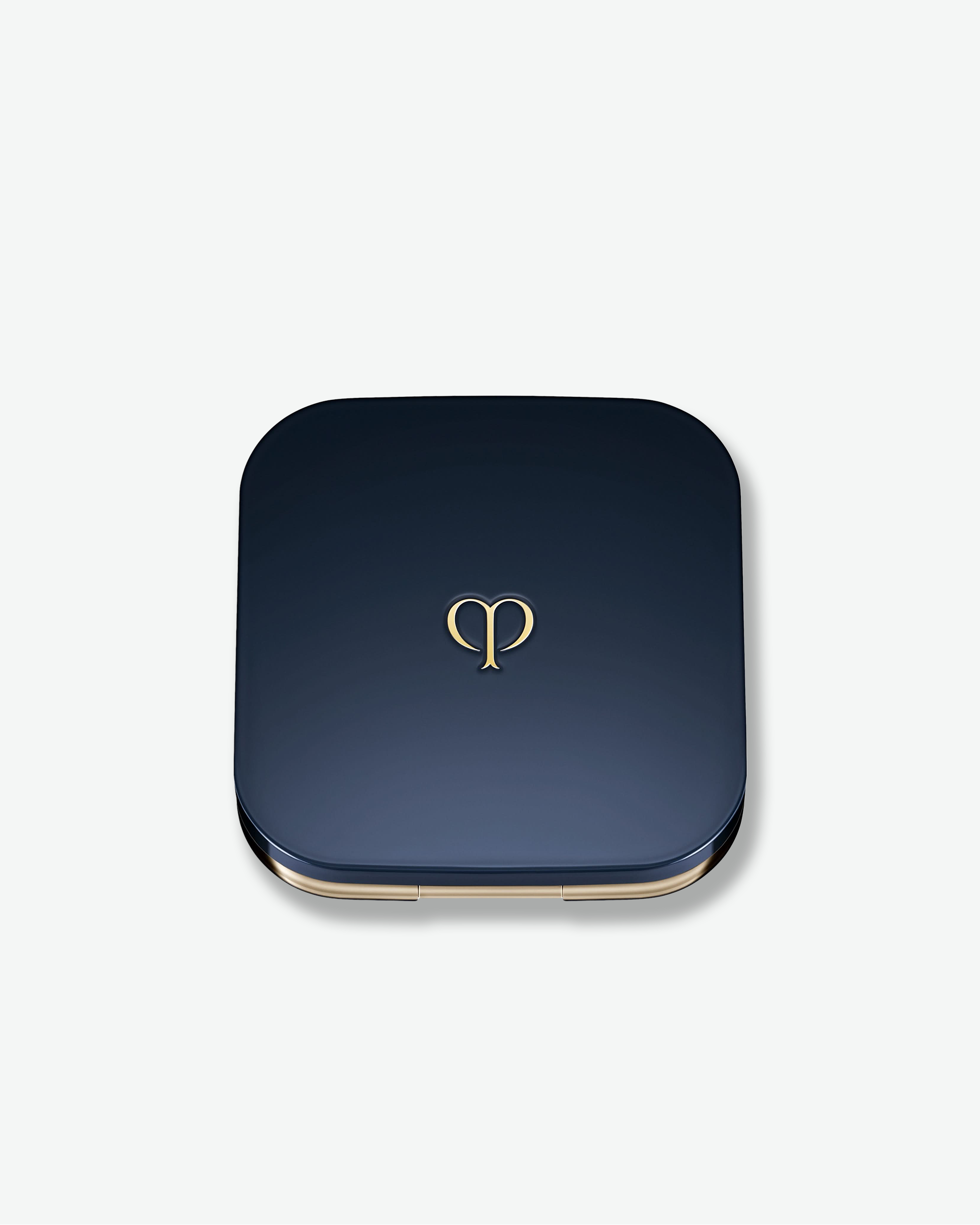 Blue square compact with gold rim and logo on a white background