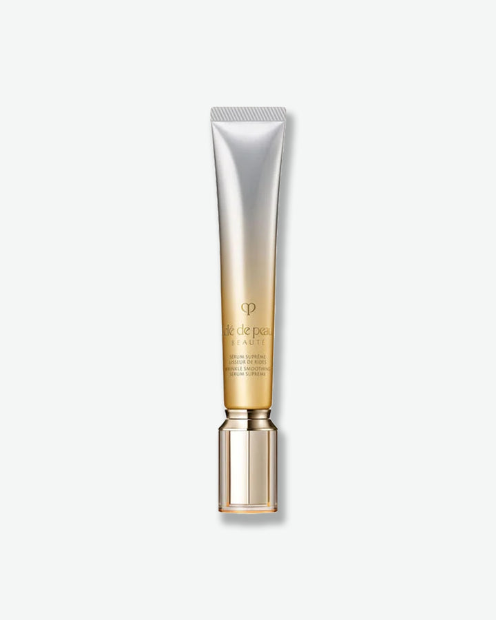 Thin silver to gold ombre colored tube with gold cap on a white background