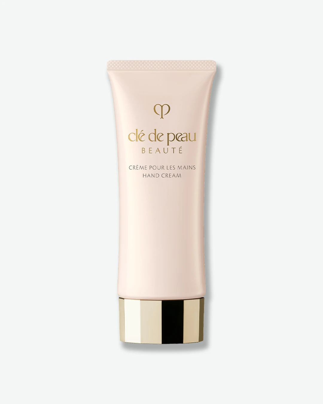 Clé de Peau hand cream tube on a white background.