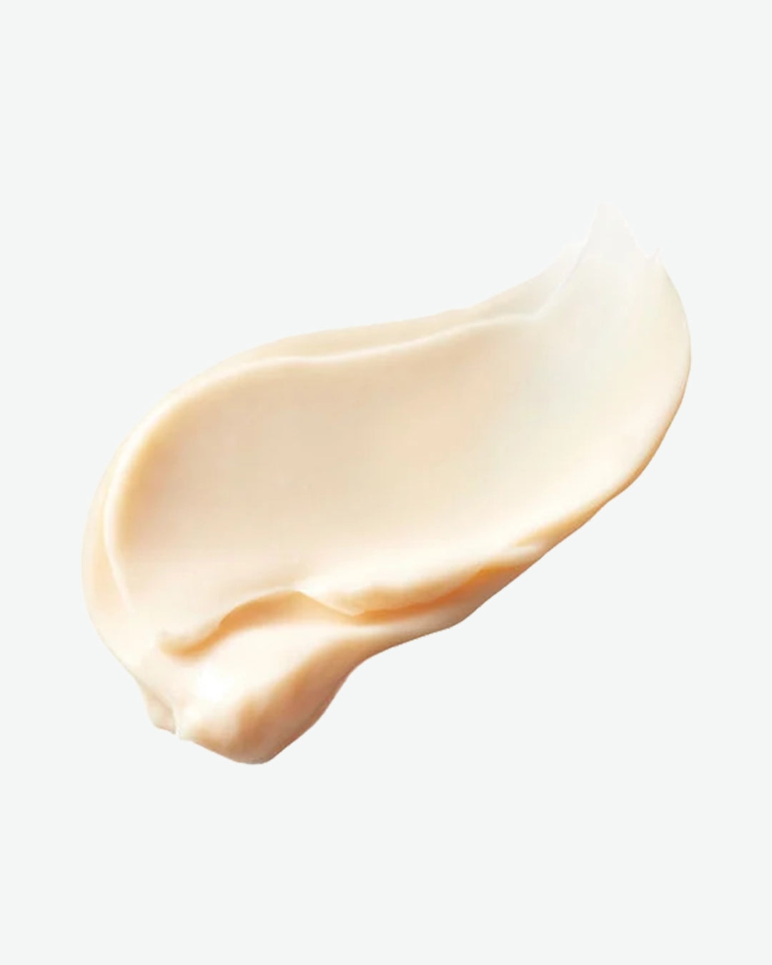 Close-up of a beige cream swatch on a light gray background