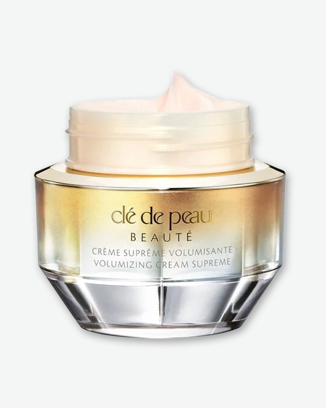 Clé de Peau beauty cream jar with lid off showing cream inside the jar on a white background