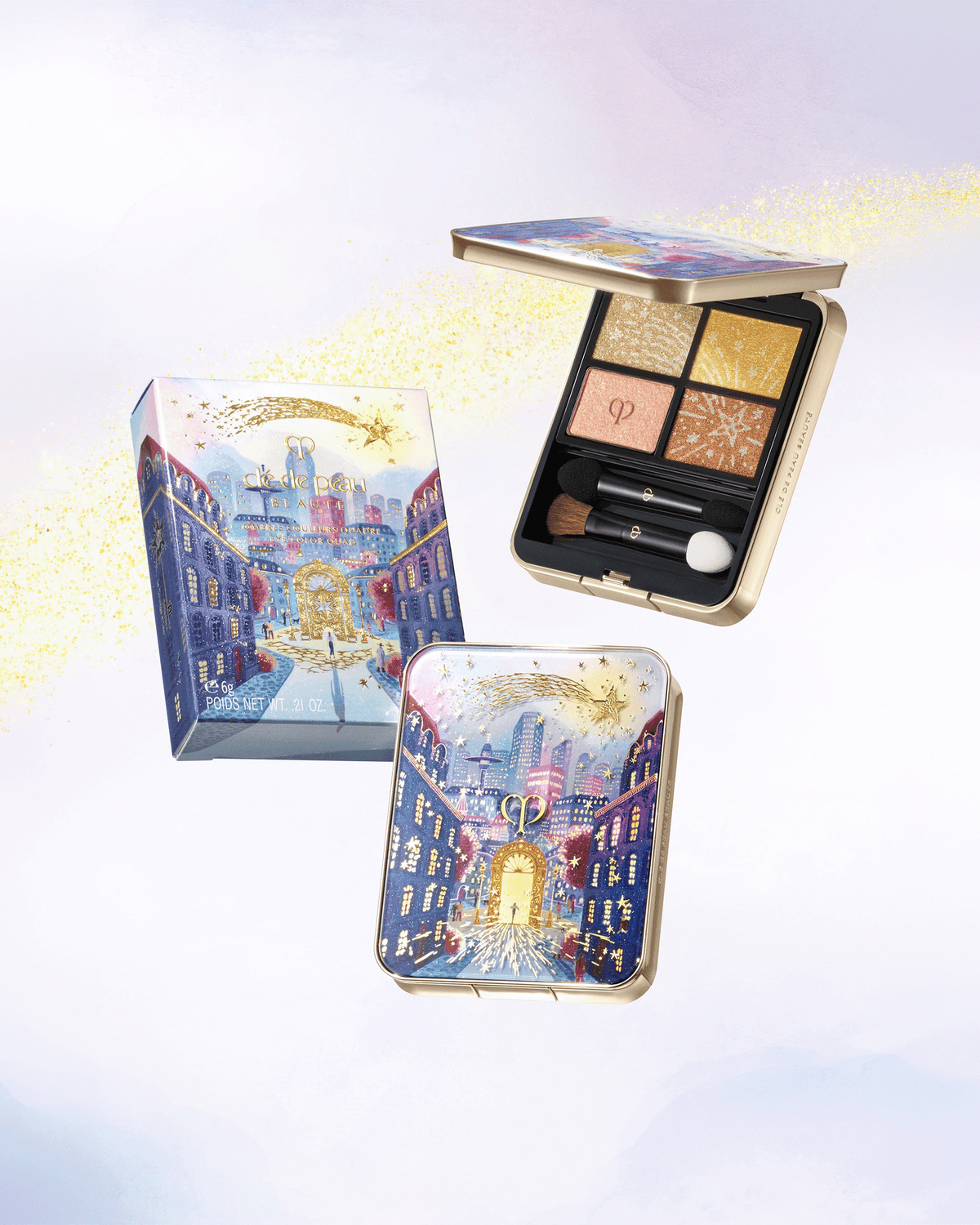 Clé de Peau Beauté limited-edition holiday eyeshadow quad displayed alongside its illustrated celestial packaging and matching compact.
