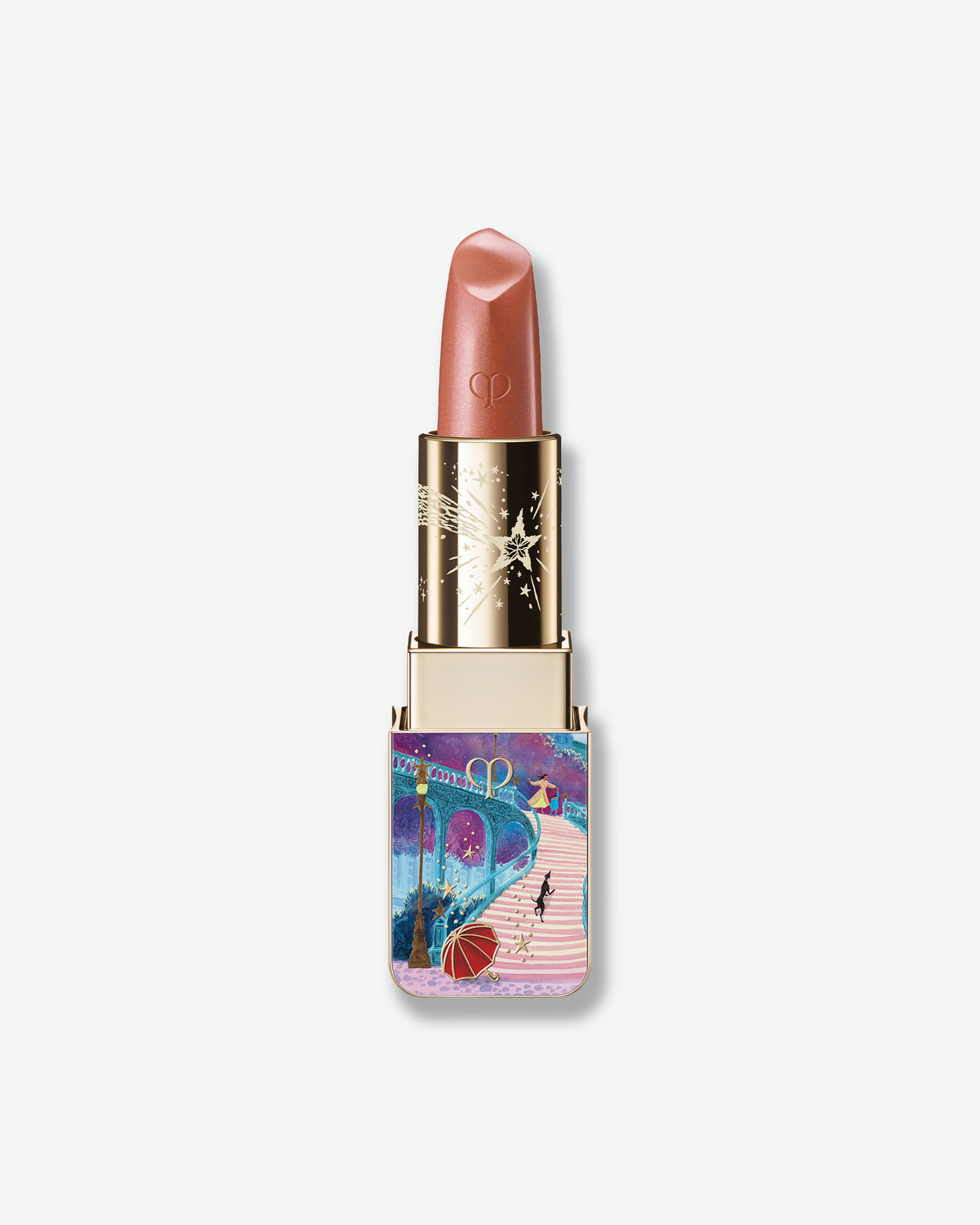 Clé de Peau Beauté limited-edition holiday lipstick in a shimmering rosy nude shade, featuring a gold case with colorful celestial artwork.