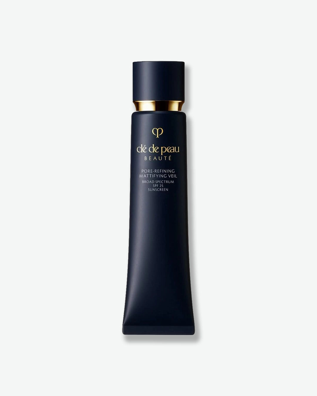 A tube of Clé de Peau Beauté Pore-Refining Mattifying Veil Broad Spectrum SPF 25 Sunscreen, featuring a sleek, dark navy body, a matching navy cap, and gold branding accents.