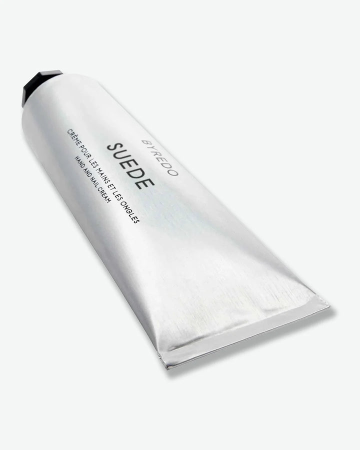 Aluminum tube of Byredo Suede hand cream on a white background