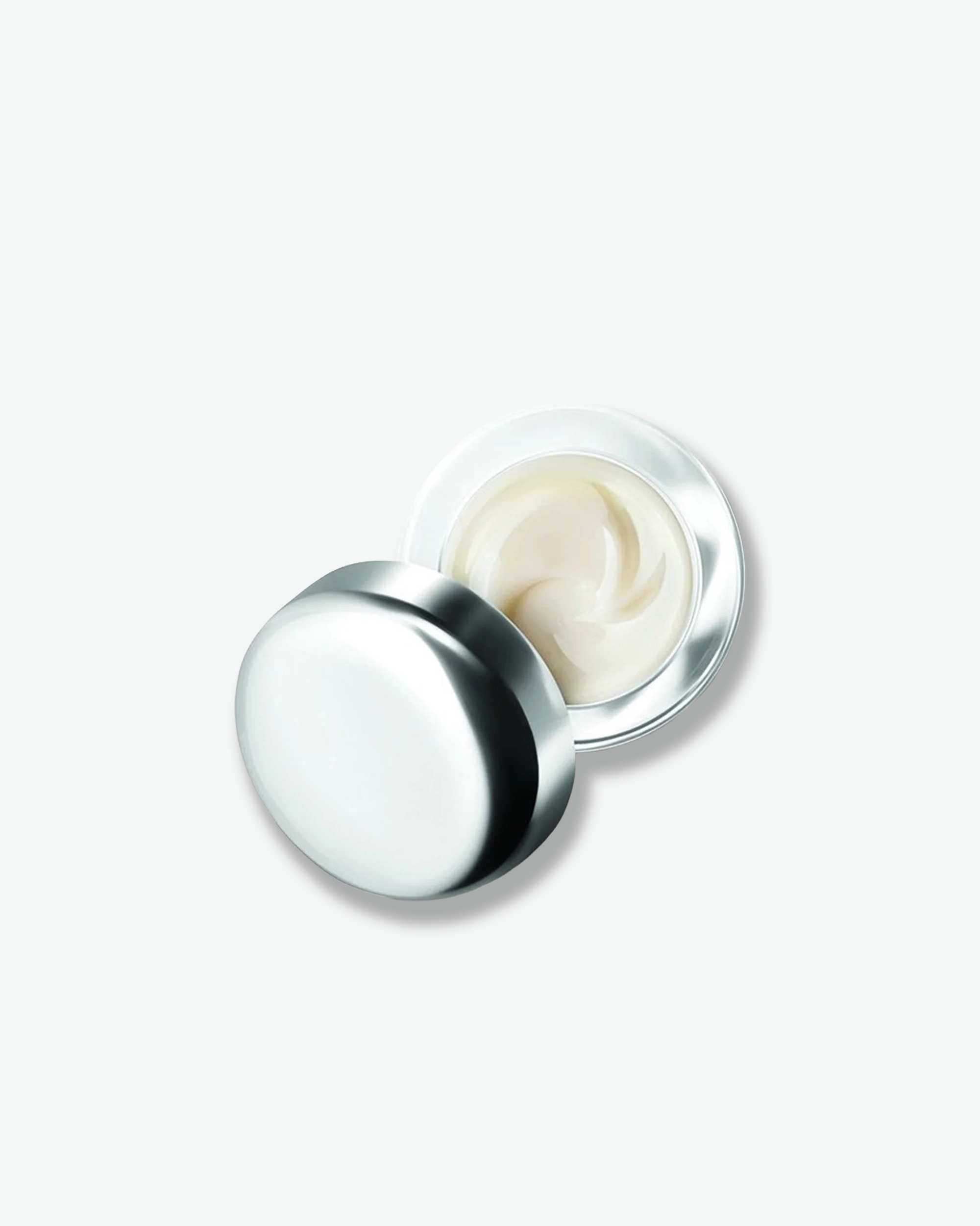 Cream jar with silver lid on a white background