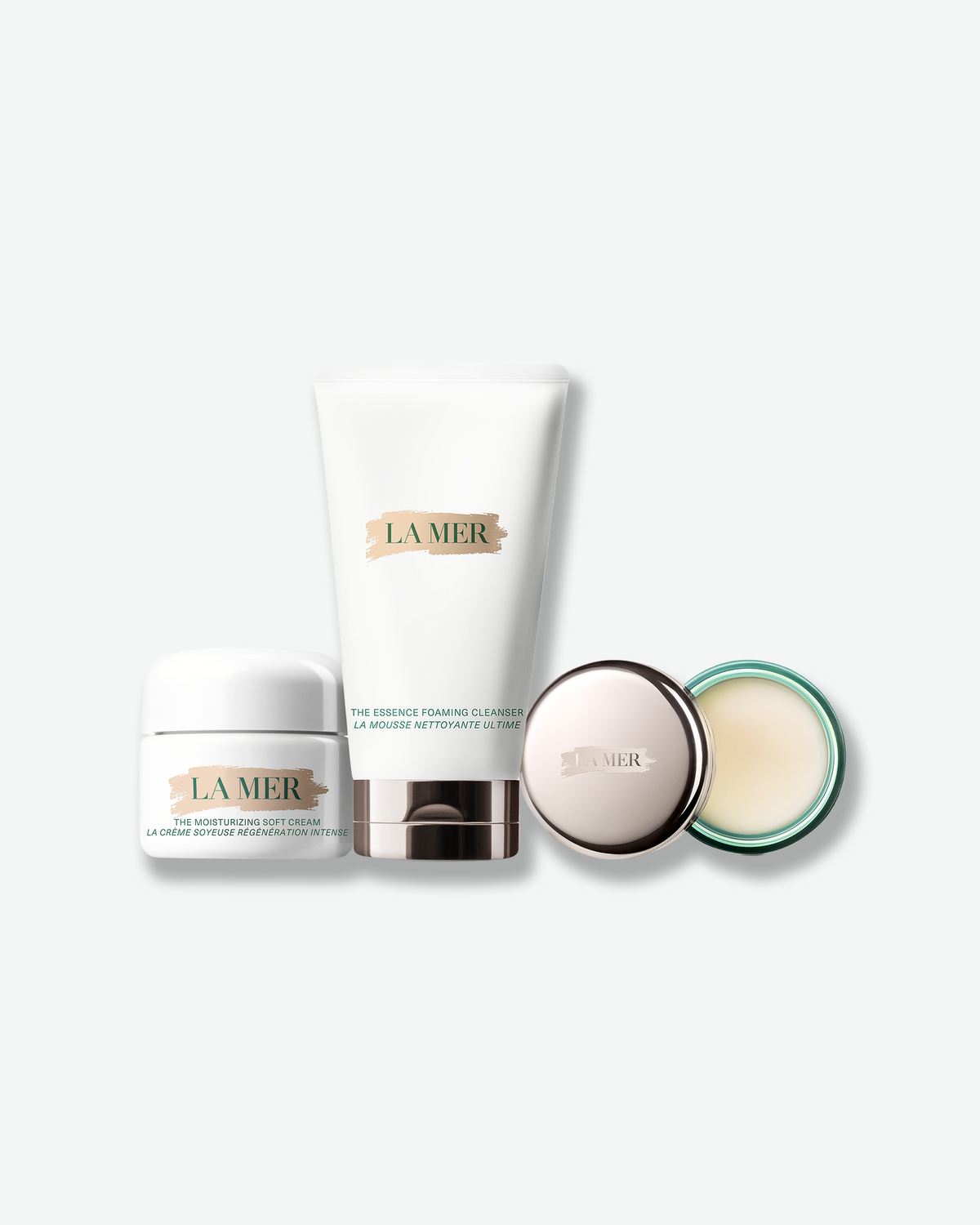 La Mer The Refresh Regimen featuring The Moisturizing Soft Cream, The Essence Foaming Cleanser, and a cleansing balm on a light background.