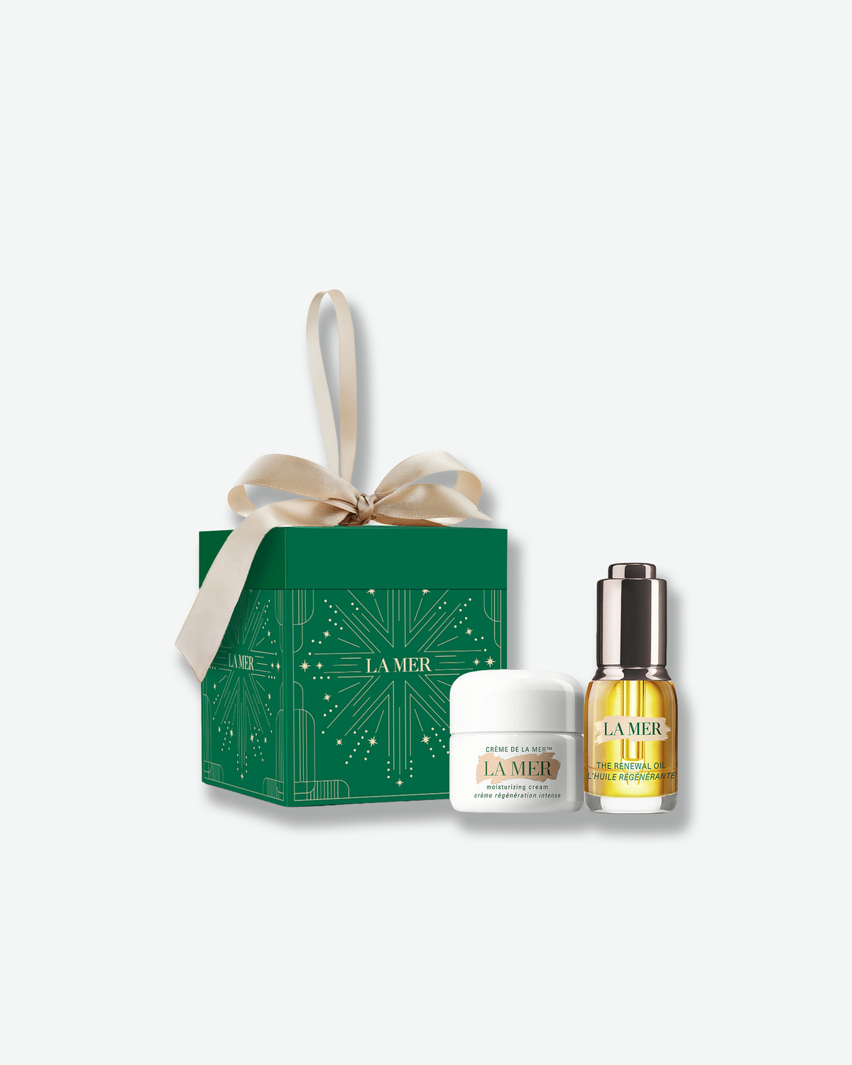 La Mer Crème de la Mer and The Renewal Oil presented with a green holiday gift box and ribbon.