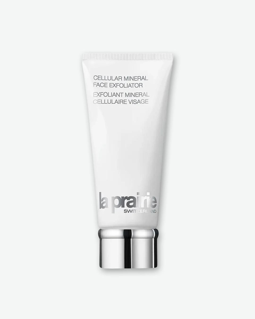 A product shot of a La Prairie Cellular Mineral Face Exfoliator tube, centered against a plain light gray background. The sleek white squeeze tube features the product name in minimalist silver text near the top. The silver metallic brand logo "la prairie SWITZERLAND" is printed near the bottom, and the tube is sealed with a ribbed chrome silver screw cap.