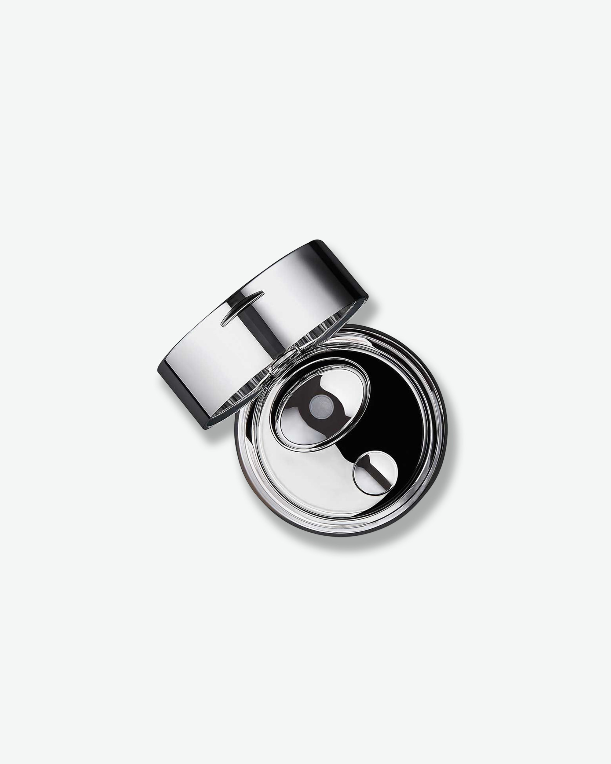 An overhead, top-down view looking into the open La Prairie Skin Caviar Absolute Filler container. The polished silver lid is angled back, revealing a sleek, mirror-like chrome interior surface with a stylized oval button mechanism designed to cleanly dispense the product.
