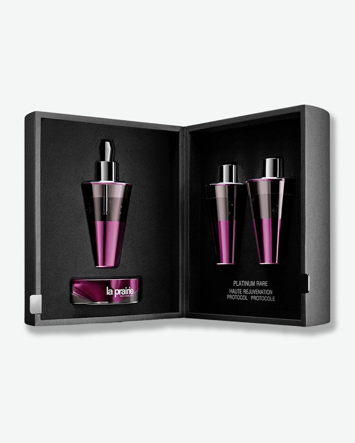 La Prairie skincare set with two bottles and a smaller container in a black open box on a white background