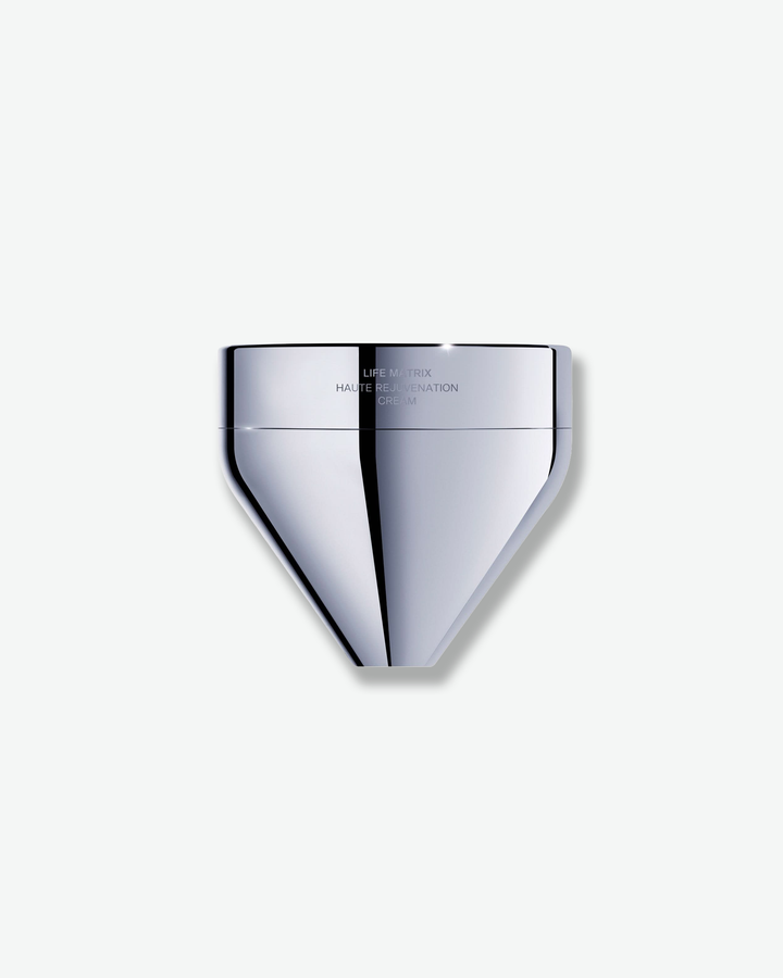 Front view of a La Prairie Life Matrix Haute Rejuvenation Cream container against a plain gray background. The futuristic vessel features a geometric, diamond- or funnel-shaped base with a highly reflective, polished chrome metallic finish and a matching flat-topped cap.