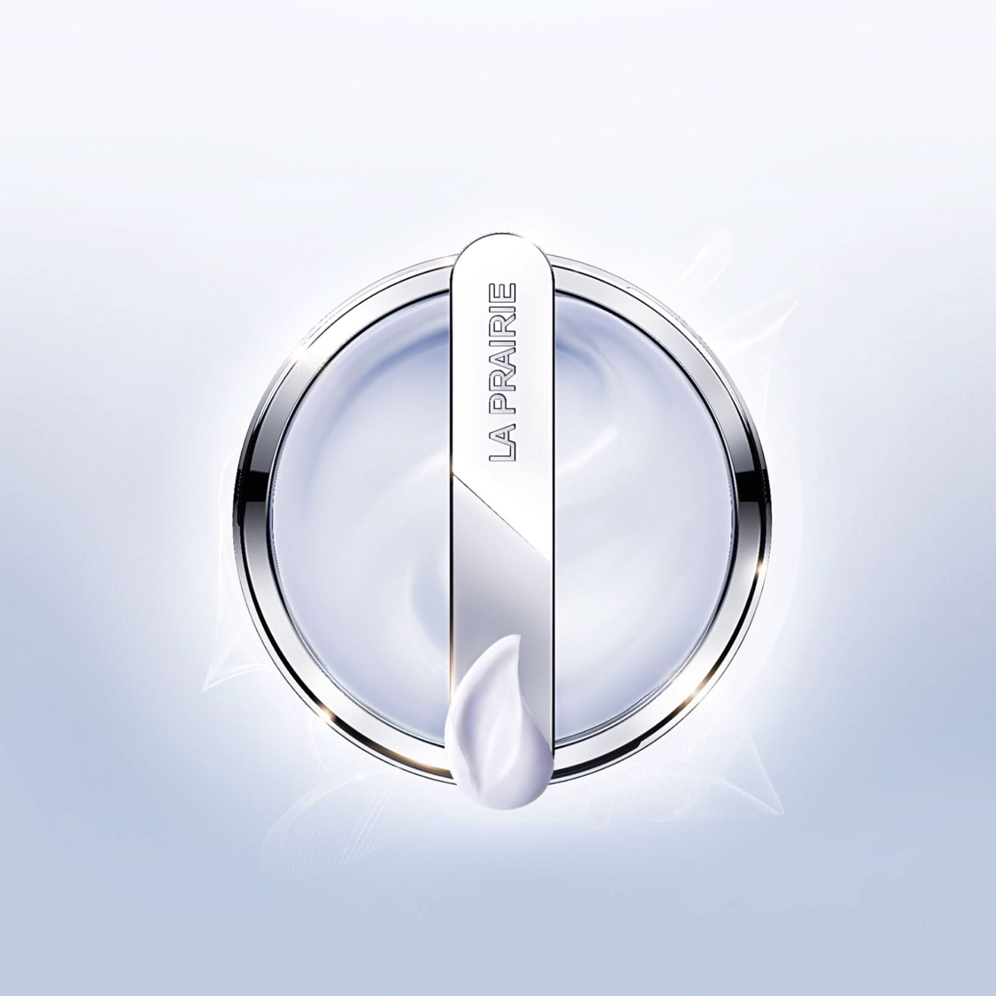 La Prairie skincare product with a droplet on a light blue background