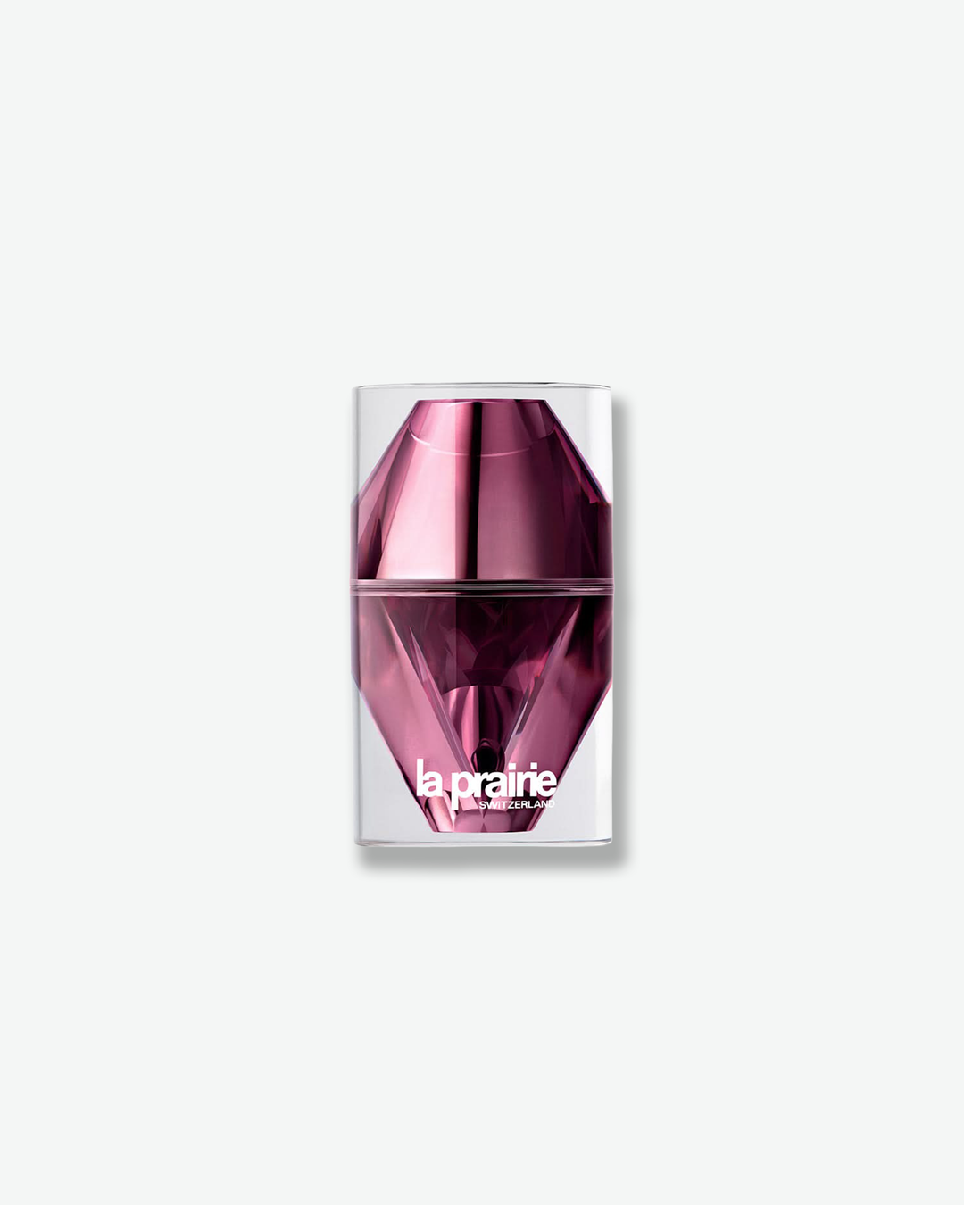 Front view of a tall La Prairie Platinum Rare elixir bottle against a plain gray background. The dramatic container displays a diamond-faceted, elongated oval inner vial in highly reflective metallic purple, crowned with a matching faceted metallic cap and suspended inside a clear, cylindrical acrylic outer case.