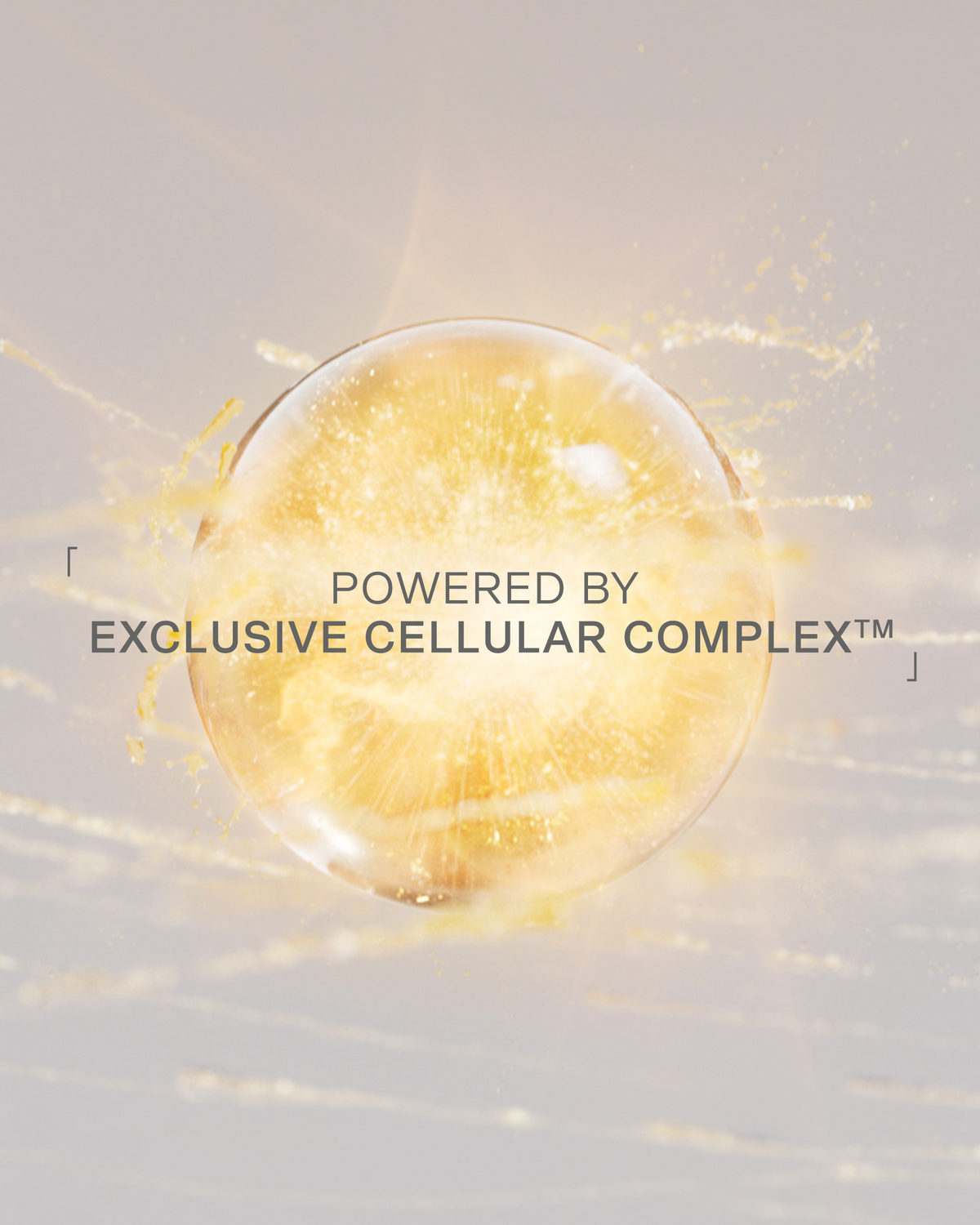 A glowing golden spherical droplet or bubble centered on a soft light beige background, with text reading 'POWERED BY EXCLUSIVE CELLULAR COMPLEX™' overlaid across the middle.