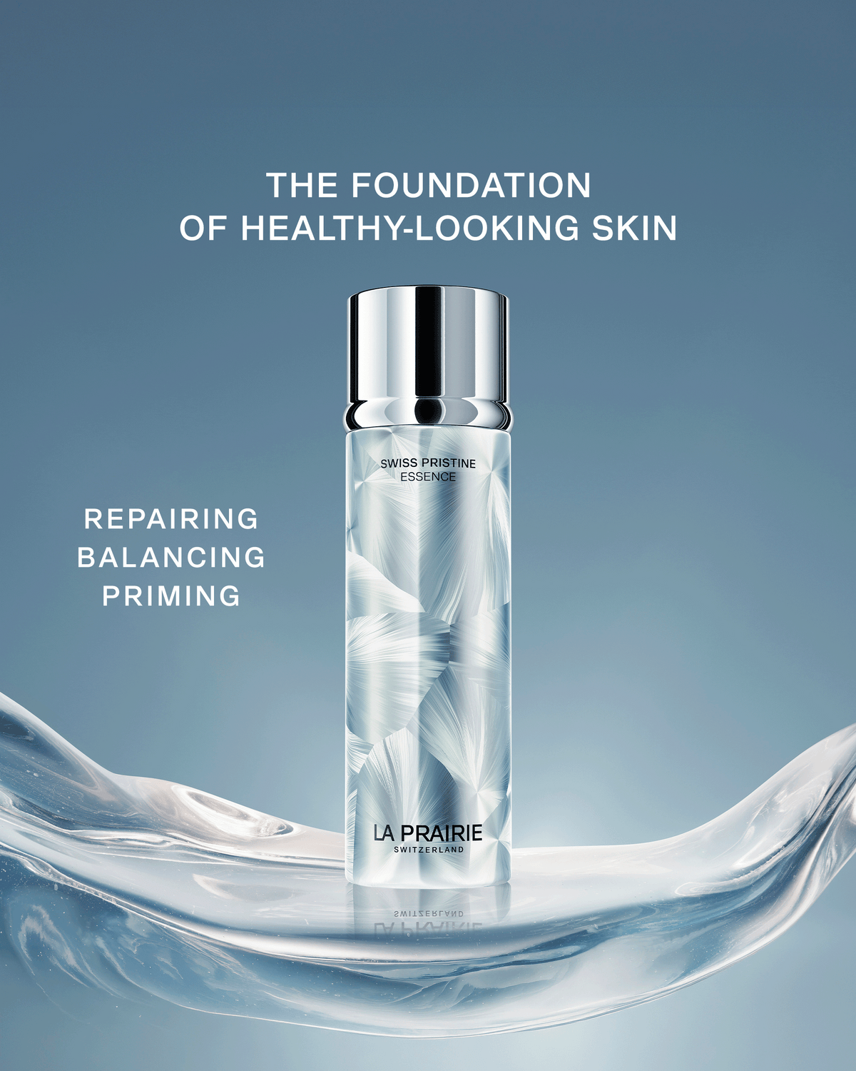 Swiss Pristine Essence displayed on a sculptural icy surface with messaging around repairing, balancing, and priming skin as the foundation of a healthy-looking complexion.