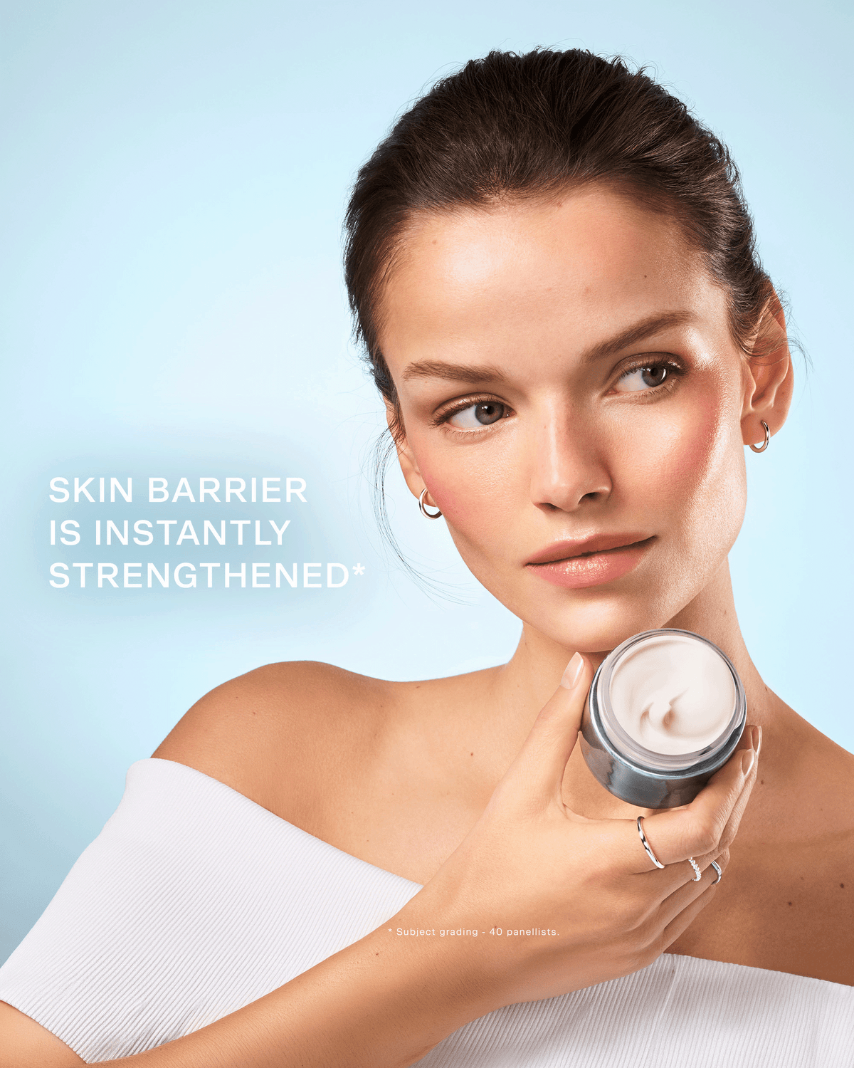 Model holding an open jar of Swiss Pristine Cream with text stating the skin barrier is instantly strengthened.