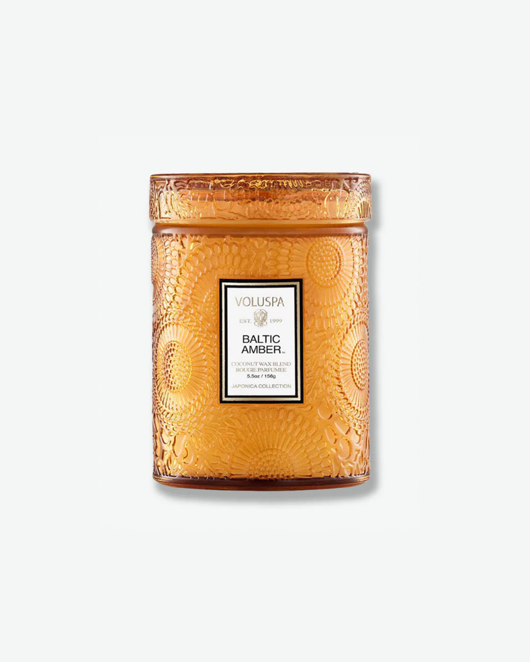 Front view of a Voluspa Baltic Amber small jar candle against a plain gray background. The warm, amber-colored glass vessel is completely detailed with an embossed floral pattern and capped with a matching textured glass screw-on lid.