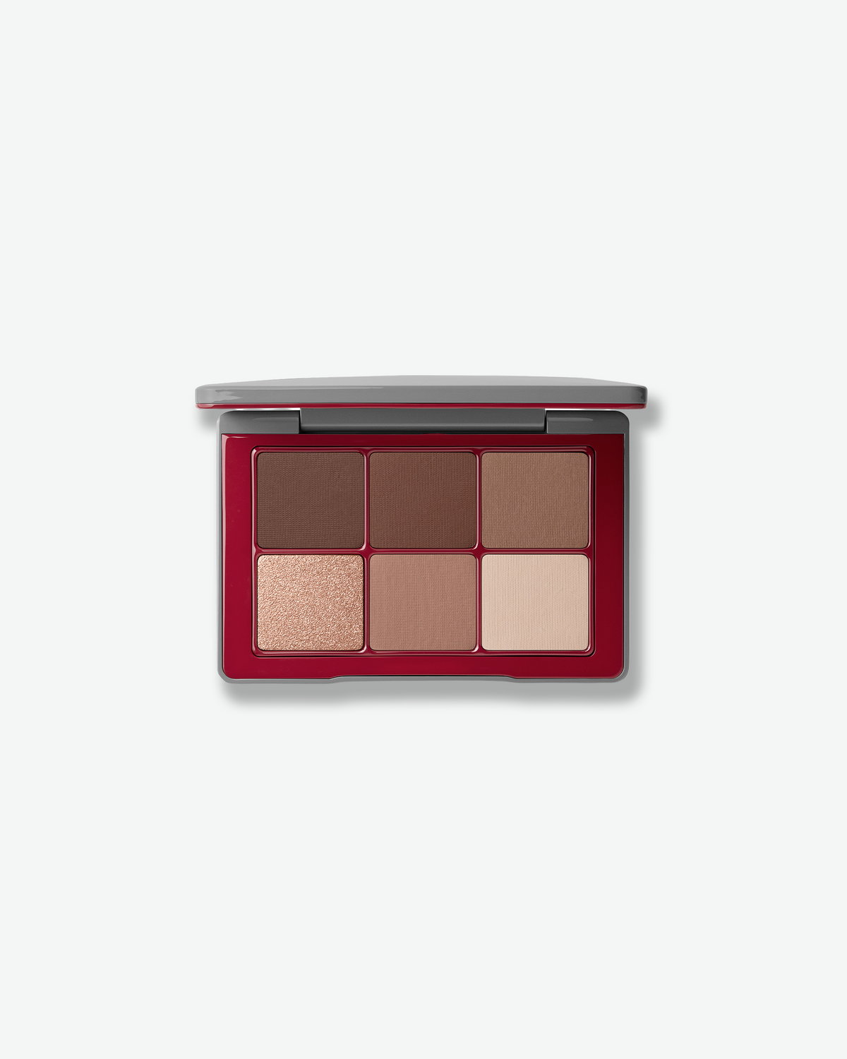 Westman Atelier eyeshadow palette featuring six neutral pressed powder shades in matte and shimmer finishes, housed in a red and silver compact.